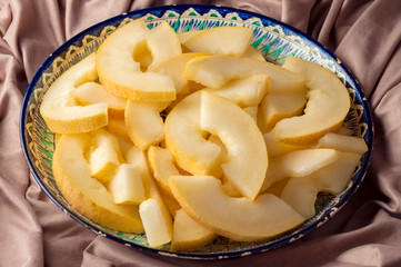 Melon wedges on a plate with oriental ornament, shallow depth of field