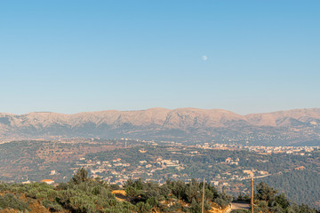 Beautiful colorful sunset over the mountain range and pine tree forest. Nature landscape. fogy sky with some orange reflections.