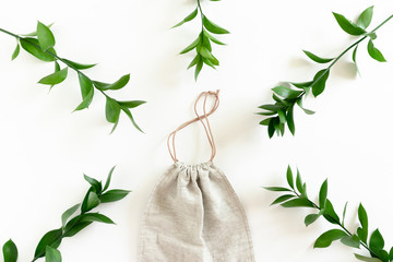 Canvas bag with frame made of ruscus branches on white background