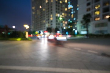 Fototapeta na wymiar Blurred modern urban city at night with street traffic