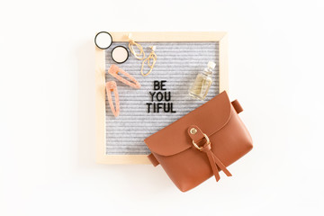 Quote Be You Tiful. Composition with letterboard, handbag, cosmetics and accessories on white background