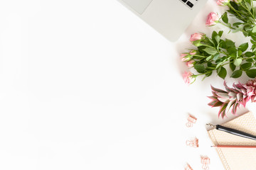 Border frame made of laptop, flowers, stationery on white background