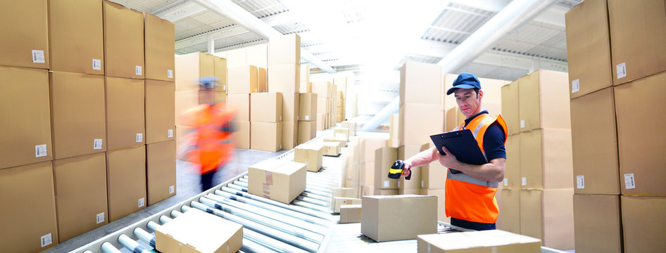 workers in a goods warehouse - storage and transport of goods by mail order
