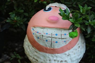 The little white sheep sculpture was smiling happily in the garden