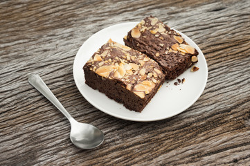 Chocolate brownies topping with almonds slices on table.