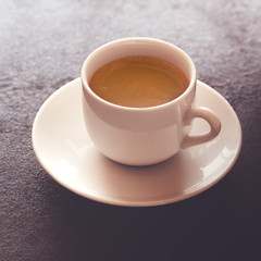 Hot cup of espresso coffee on a table