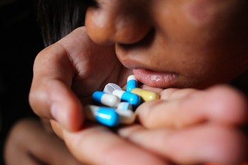 Young women are taking drugs, sitting in low light