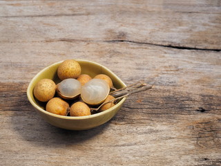 view of delicious Longan Thai fruit (Dimocarpus longan) on wood texture background.