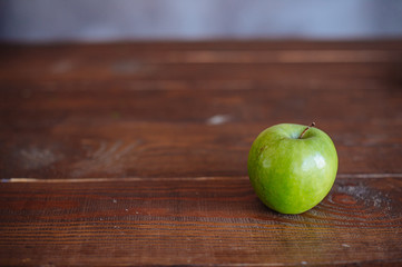 Green apple, isolated on wood table
