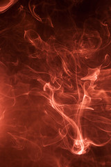 Red smoke on a black background.