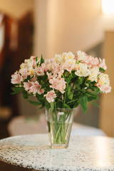 Flower shop concept. Different varieties fresh spring flowers in refrigerator room for flowers. Bouquets on shelf, florist business.