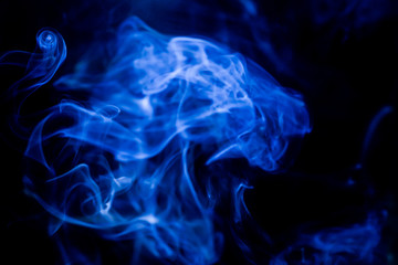Blue toxic fumes movement on a black background.