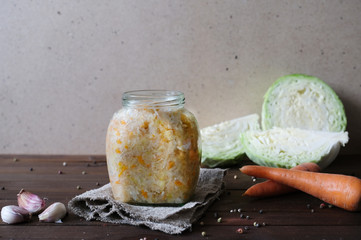 Pickled cabbage with carrot in glass jar. Homemade preserving. Fermented food.