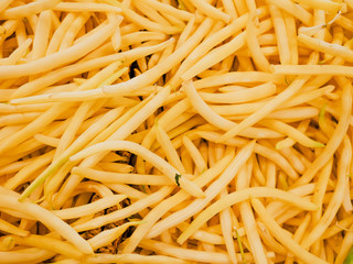Heap of fresh yellow butter beans for sale in the market top view