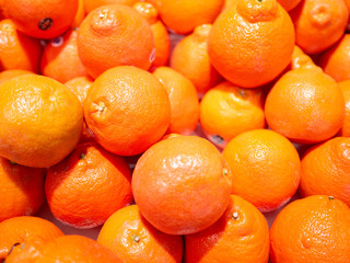 Bunch of fresh oranges mandarins for sale in the market close up top view