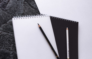 notebook and pen black and white background