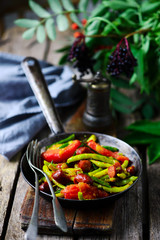 Green Beans with Sausages and Tomatoes.style rustic.selective focus