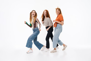Obraz premium Portrait of three gorgeous girls wearing casual clothes smiling and having fun together