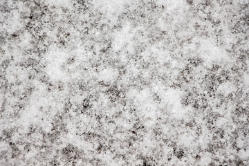 Texture of snow on asphalt. Winter abstract background_