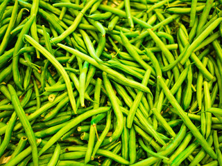Bunch of fresh green stringless beans for sale in the market top view