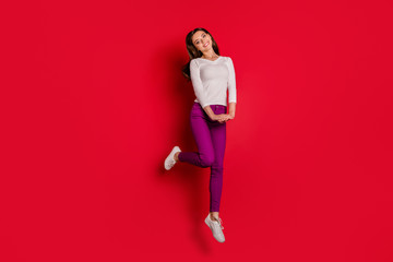 Fototapeta na wymiar Full length body size photo of jumping shy cute fascinating woman admiring something while isolated with red background