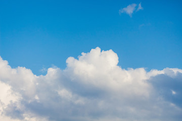 Naklejka na ściany i meble Blue sky with white curly clouds in sunny weather_