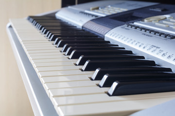 A synthesizer or electronic piano keys. Musical education for kid in music school.