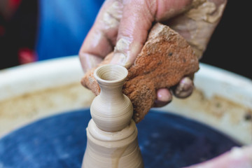 Making a vase on a potter's wheel. Potter at work_