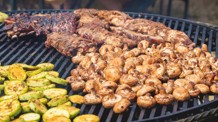 Grilling meat, zucchini and mushrooms. Delicious food for tourists_