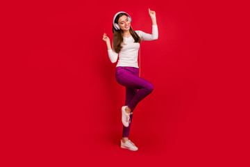 Fototapeta na wymiar Full length body size photo of dancing girl imagining herself at disco while isolated with red background
