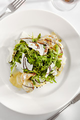 Gourmet, restaurant, delicious dinner food - close up of Salad with Quail Wings and Parmesan Cheese