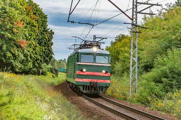 Freight train moves on the countryside background.