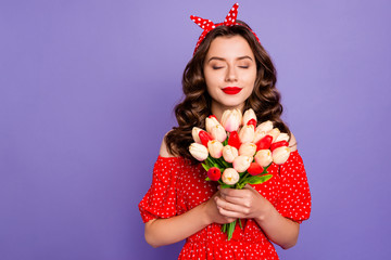 Photo of pretty lady holding big tulips bunch hands enjoy smell wear red dress isolated purple...