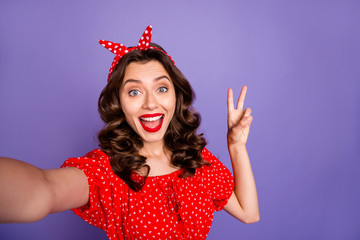 Closeup photo of pretty lady making selfies showing v-sign symbol wear red dress isolated purple background