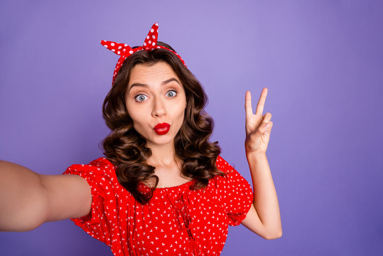 Photo of pretty lady making selfies showing v-sign symbol wear red dress isolated purple background