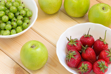 Natural homegrown products background. Top view. Close-up fruits and berries on wooden table.