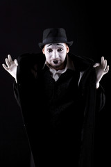 mime shows theatrical emotions on black background