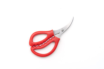 Open pair of scissors with red handle isolated on white background, top view