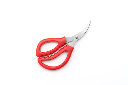 Open pair of scissors with red handle isolated on white background, top view
