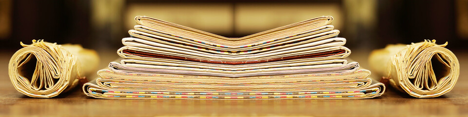 Long horizontal banner with rolled and folded newspapers and magazines in retro style. Concept for...