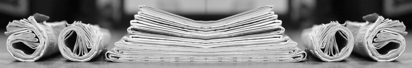 Long horizontal banner with rolled and folded newspapers and magazines in retro style. Concept for news and information - could be used for web design or advertisement - obrazy, fototapety, plakaty