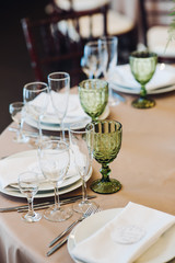 Beautiful composition with flowers on the tables and candles for guests at a wedding or a birthday party
