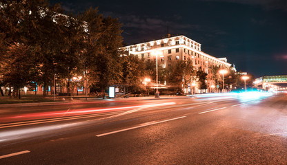 Fototapeta na wymiar The city lights at night. Traffic on the road. Moscow at night.