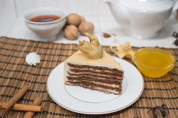 chocolate cake slice with a white cup of tea and a handful