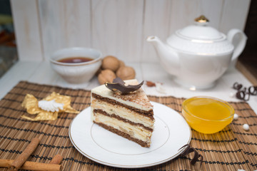chocolate cake slice with a white cup of tea