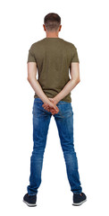 Back view of man in jeans.