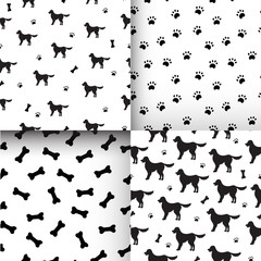 Set of Seamless patterns with black silhouettes of cartoon labrador retriever dogs, bones and paws on white