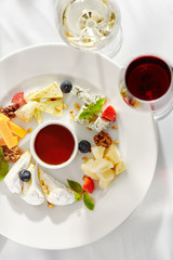 Gourmet, restaurant, delicious dinner food - close up of cheese plate with honey dip and fresh berries