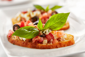 Italian Appetizer Bruschetta with Tomatoes, Cheese and Basil