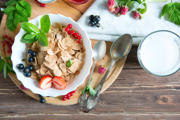 Ingredients tasty healthy breakfast for cooking with milk. Healthy tasty breakfast multigrain wholewheat healthy cereals with strawberries, raspberries, black currants and red currants.